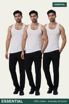 Three male models wearing white sleeveless tank tops and black pants, standing against a light gray background. The word 'ESSENTIAL' appears in a dark green banner at the top right and bottom left, with additional text 'ESSENTIAL Everyday Comfort - Cotton-Rich' at the bottom.